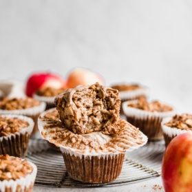 two apple cinnamon baked oatmeal cups in a stack with a bite taken out