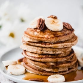 banana oatmeal pancakes in a stack on a plate