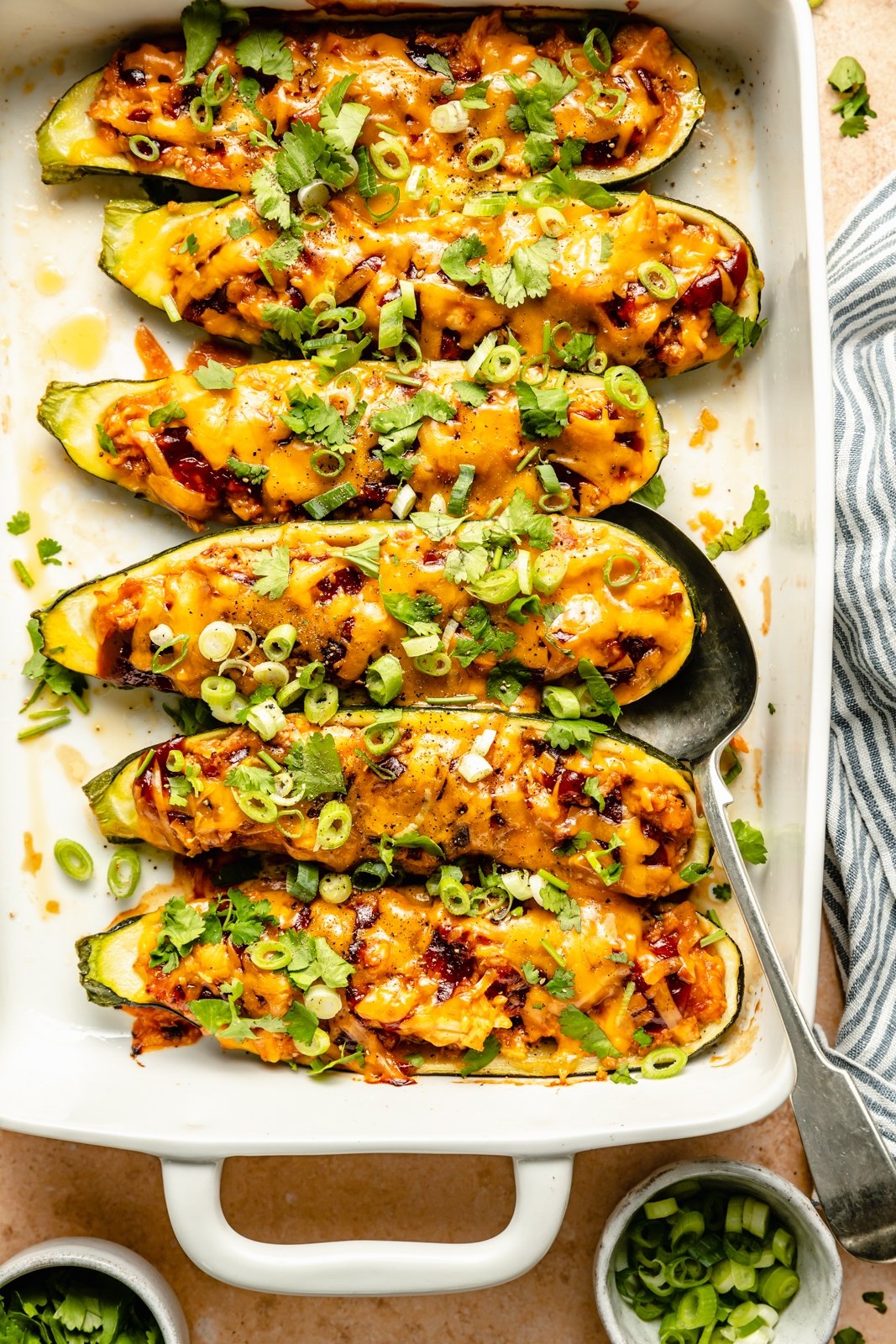 low carb bbq chicken zucchini boats in a baking pan