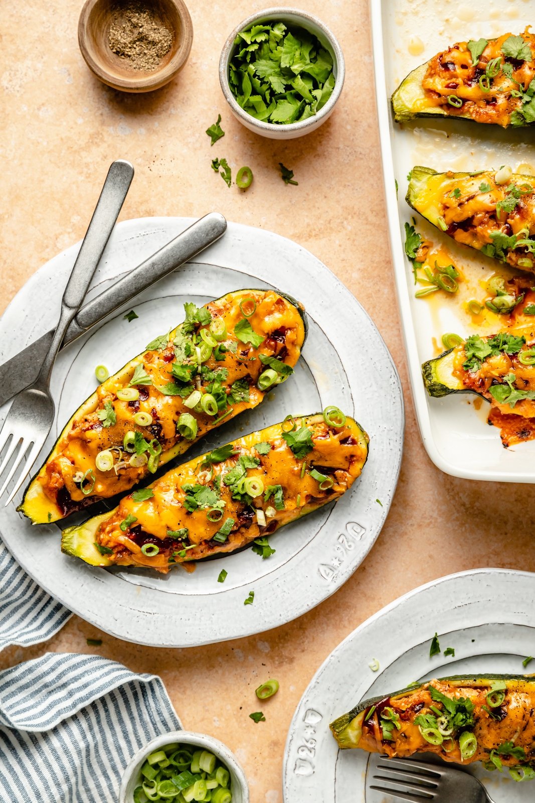 two healthy bbq chicken stuffed zucchini boats on a plate