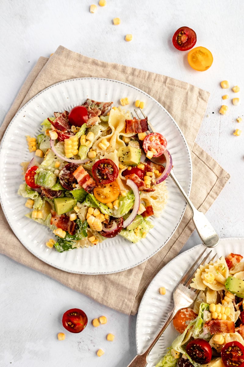 easy BLT pasta salad on two plates with forks