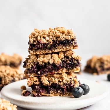blueberry pie bars in a stack on a plate