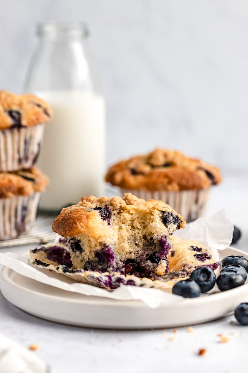 homemade blueberry muffin on a plate with a bite taken out