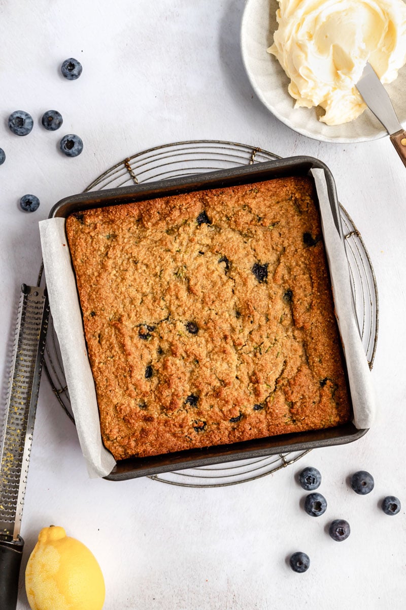 unfrosted healthy blueberry zucchini cake in a square pan