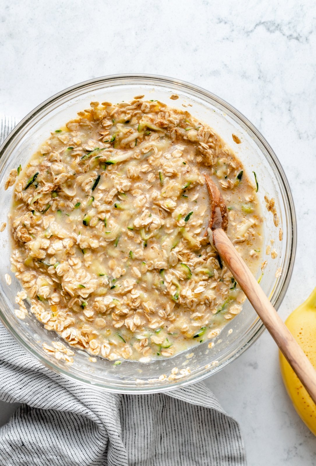 mixing batter for banana zucchini baked oatmeal in a bowl