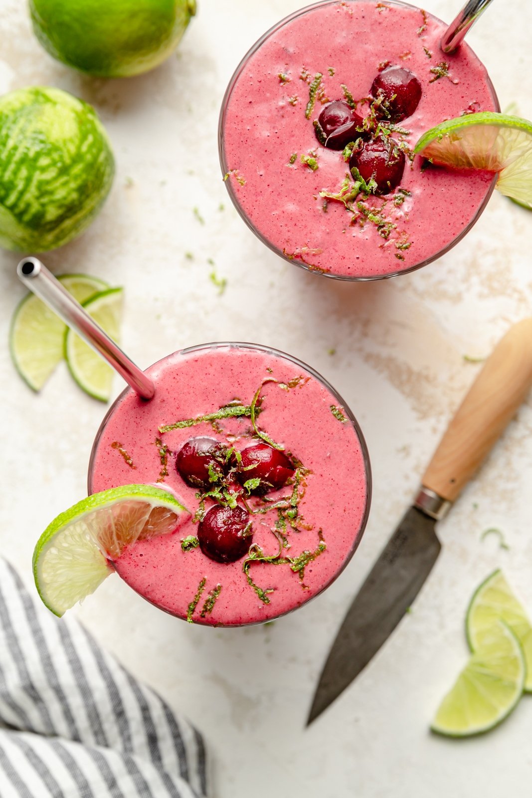 top-down view of two cherry lime smoothies