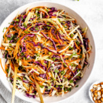 healthy coleslaw in a bowl with two serving spoons
