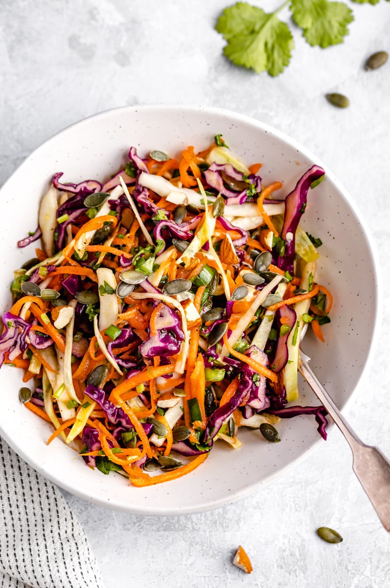 healthy coleslaw in a bowl with a fork
