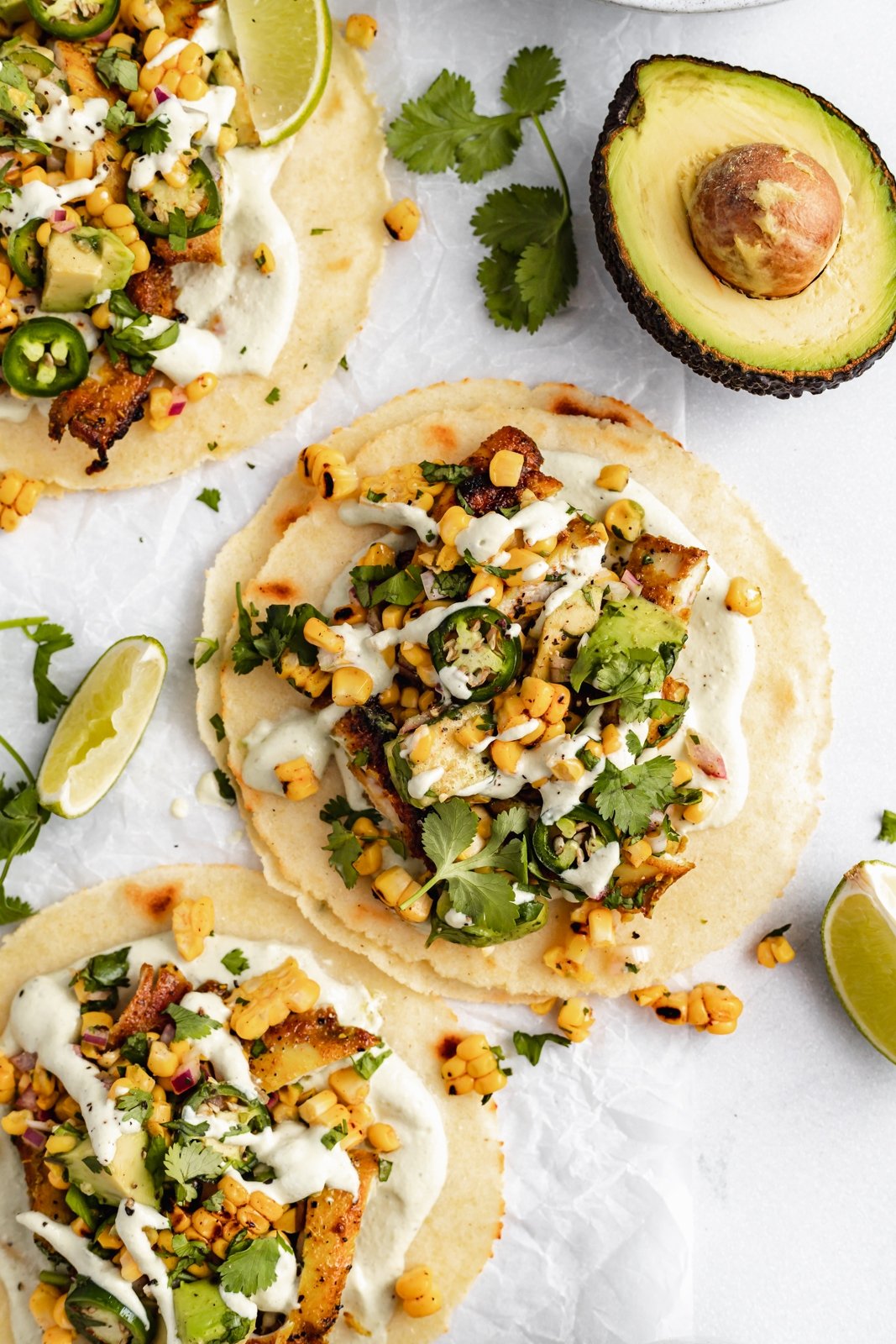 healthy street corn chicken tacos on parchment paper