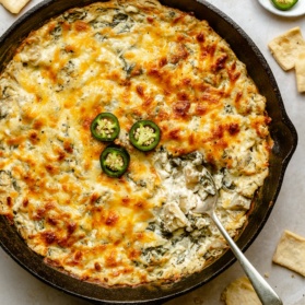 spinach artichoke dip with jalapeño in a skillet