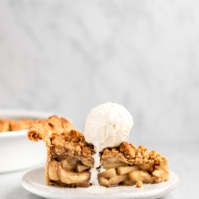 slice of dutch apple pie on a plate topped with ice cream