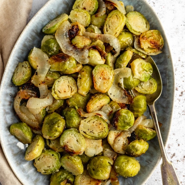 foil pack grilled brussels sprouts in a dish with a spoon