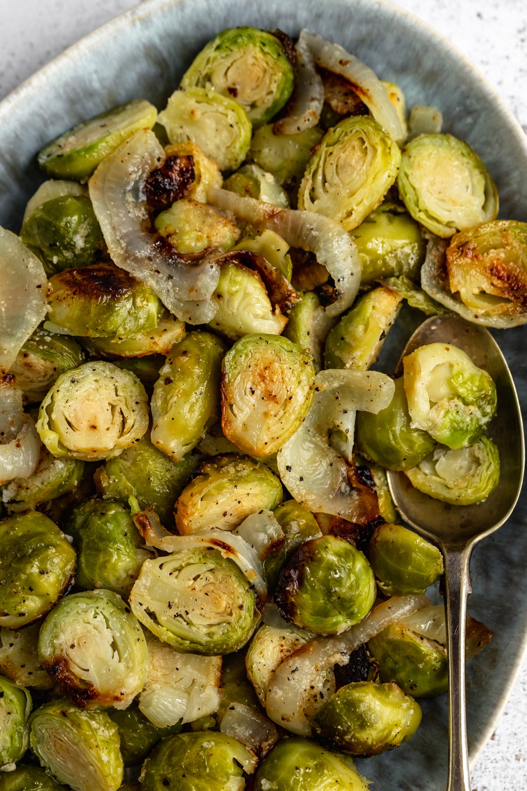 easy grilled brussels sprouts in a dish with onion
