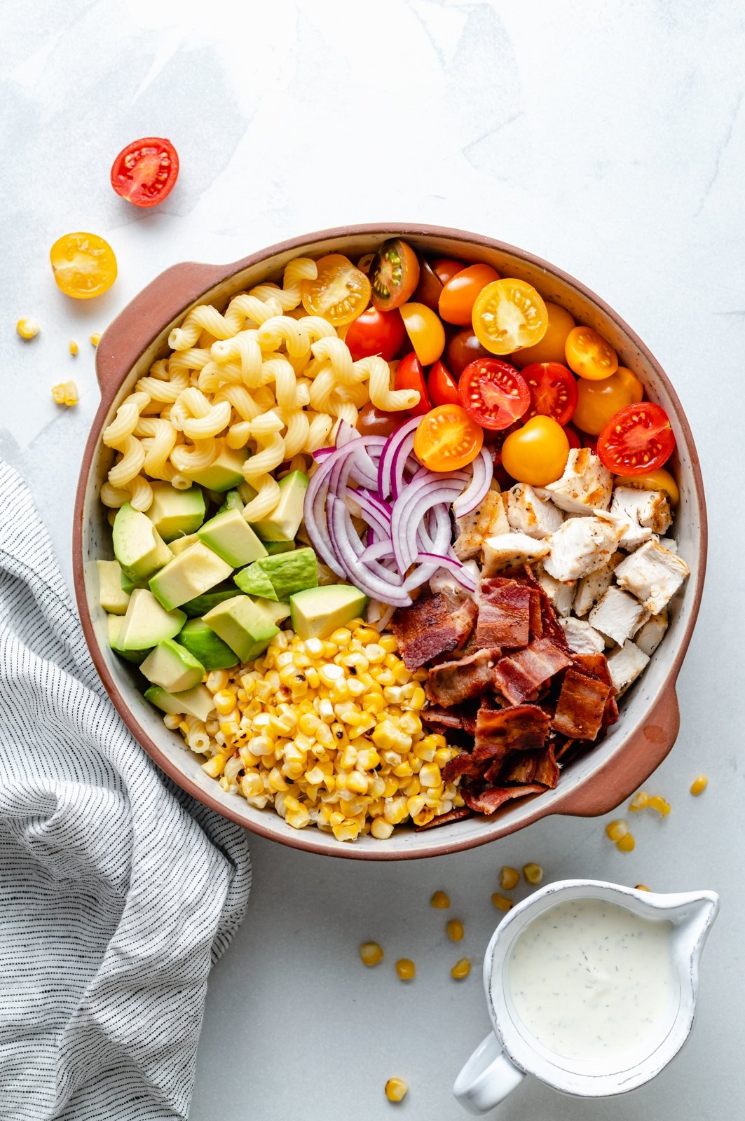 chicken bacon pasta salad unmixed in a bowl