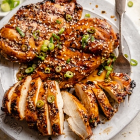 grilled sesame chicken sliced on a plate