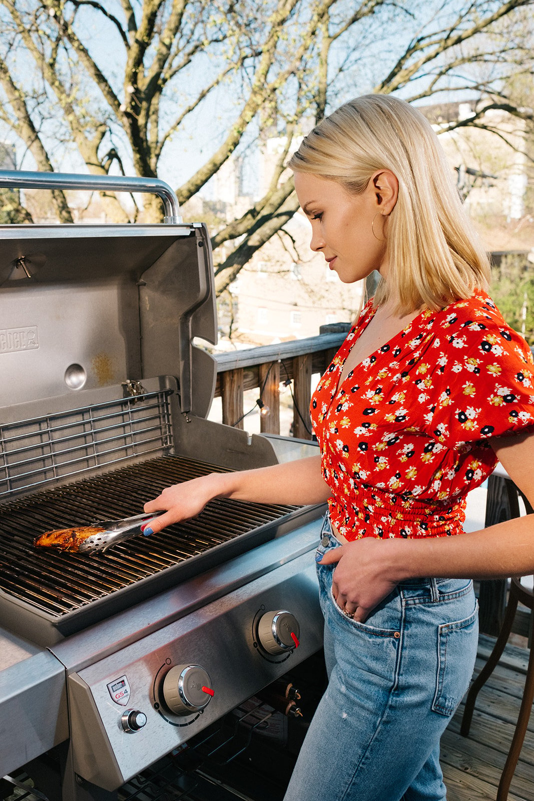 woman grilling a chicken breast