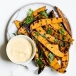 grilled sweet potato fries on a plate with yogurt dip