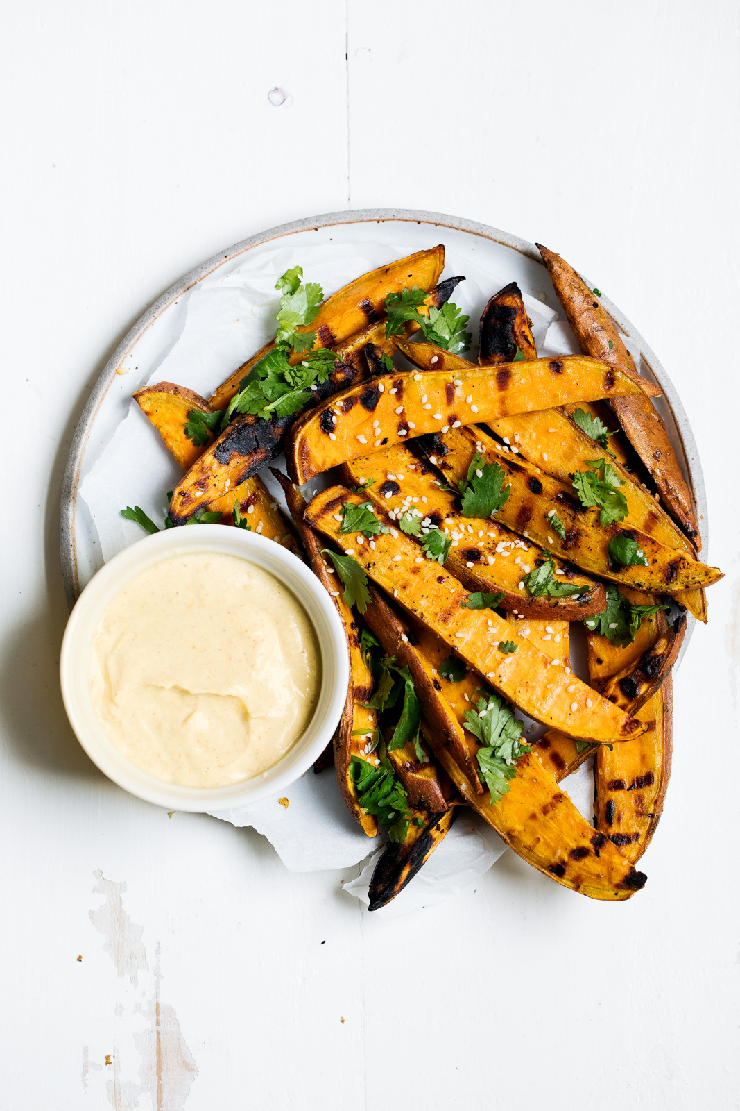 grilled sweet potato fries on a plate with yogurt curry dip