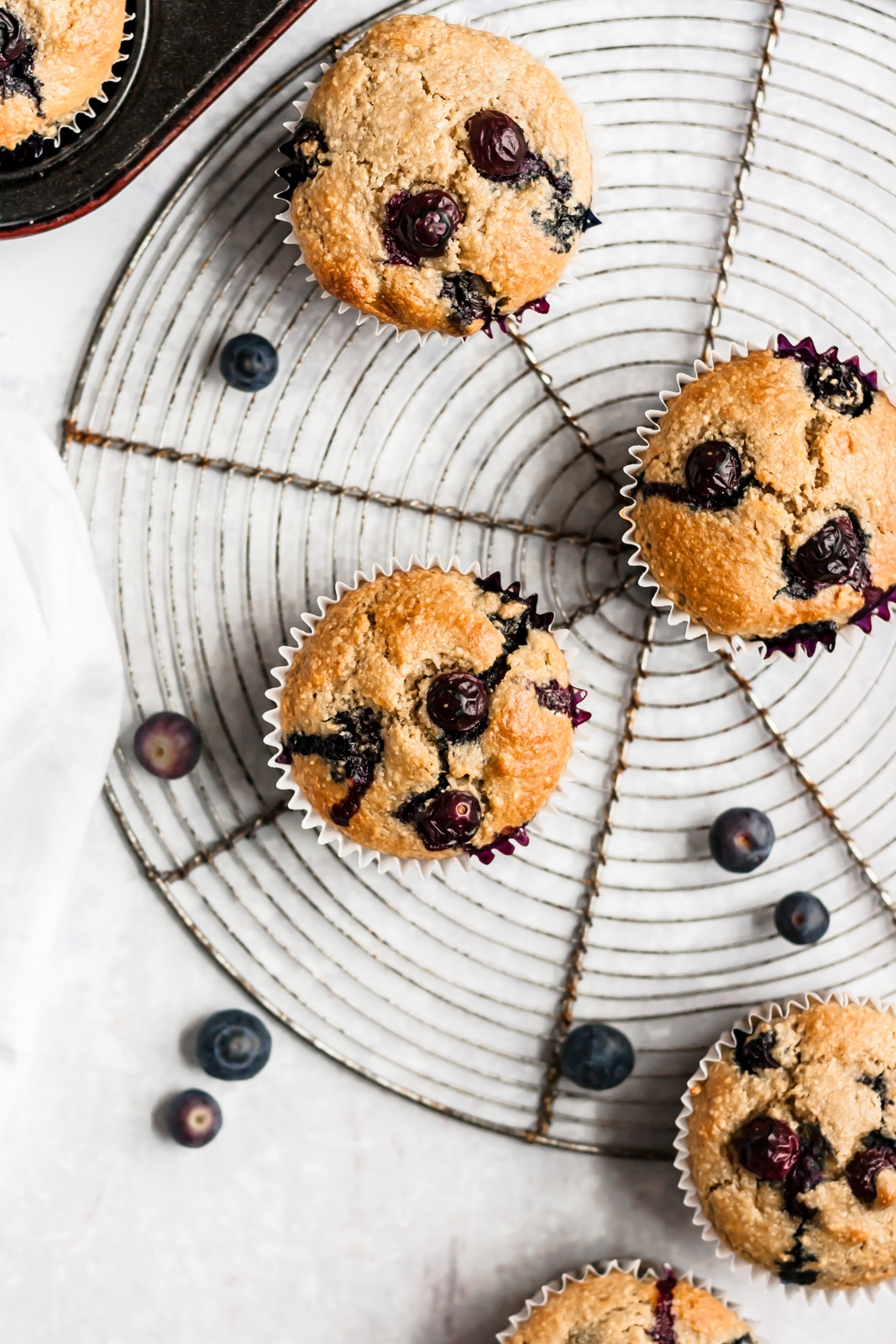 healthy blueberry oatmeal muffins on a round wire rack