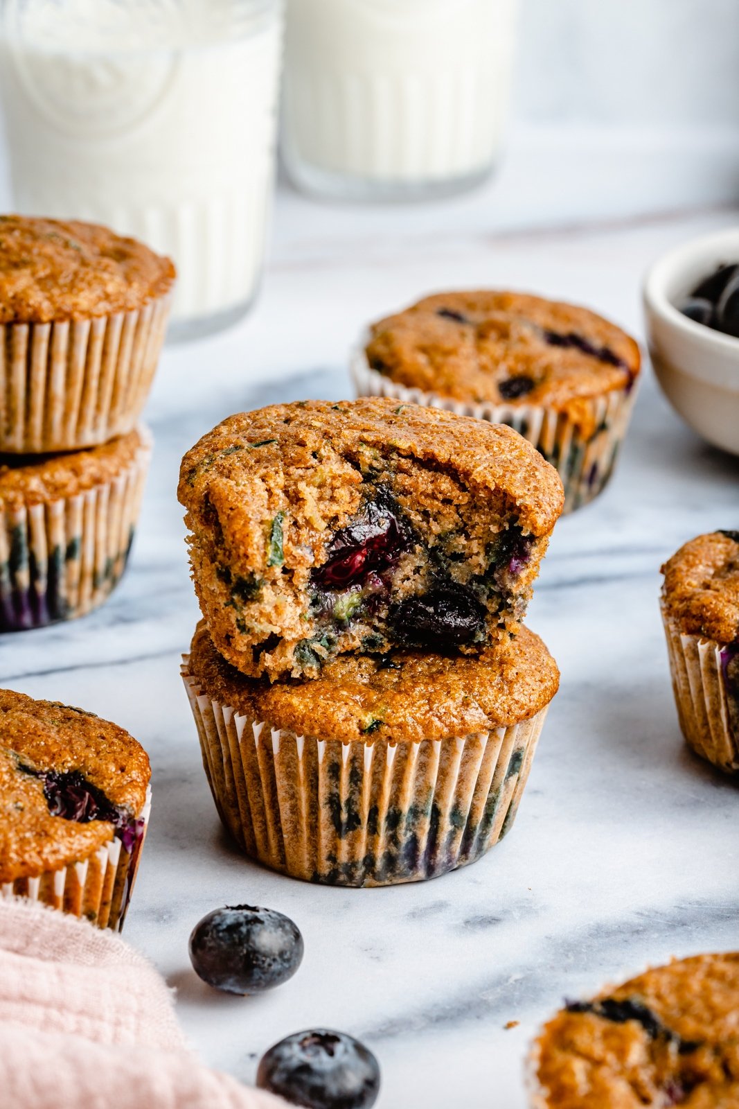 two blueberry zucchini muffins in a stack