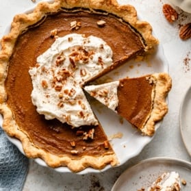 healthy pumpkin pie with whipped cream in a pan