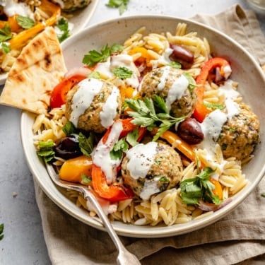 Greek turkey meatballs with orzo and veggies in a bowl