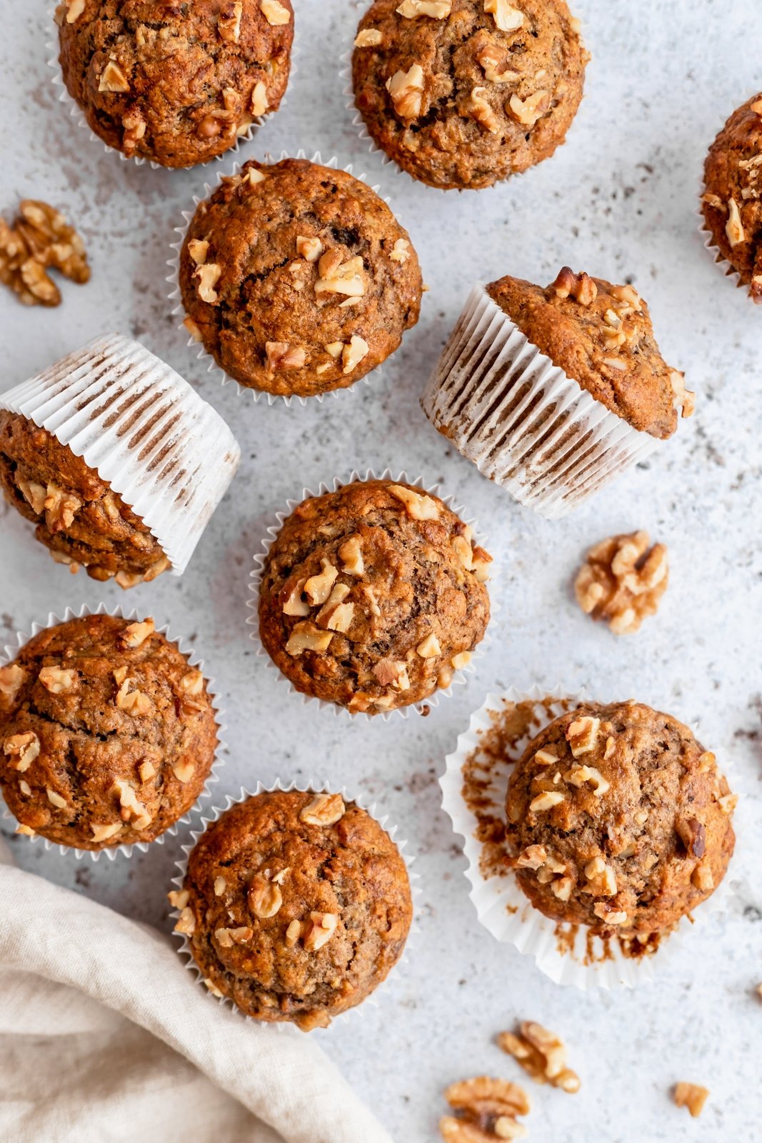 healthy banana muffins on a board with walnuts