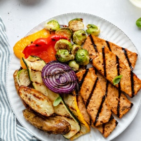 grilled tofu on a plate with vegetables