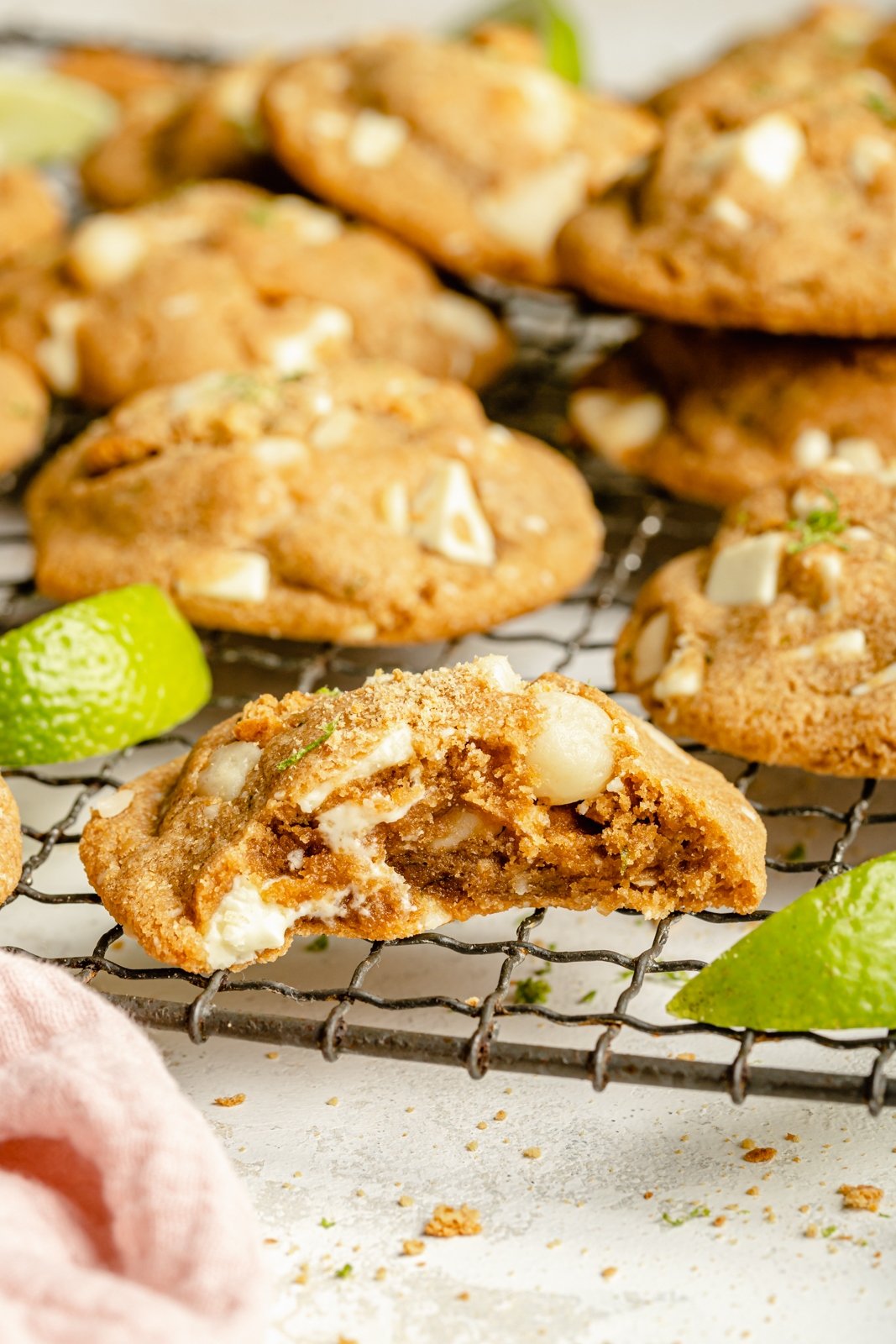 key lime cookie on a wire rack with a bite taken out