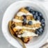 lemon blueberry oatmeal bake in a bowl with blueberries
