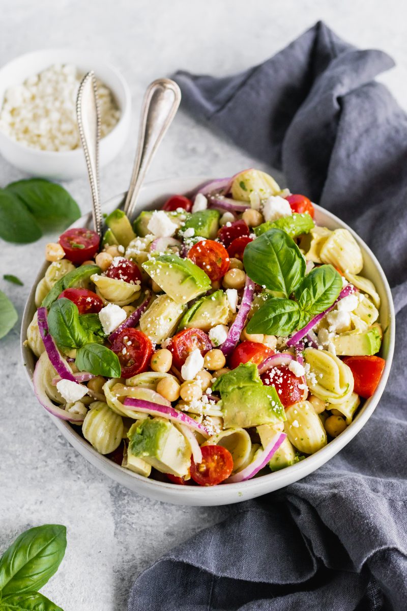 mediterranean pasta salad in a bowl with two spoons