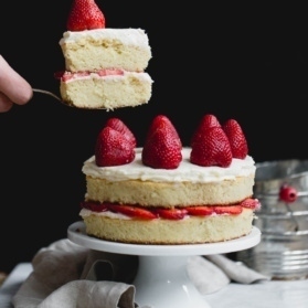 gluten free strawberry shortcake cake on a cake stand