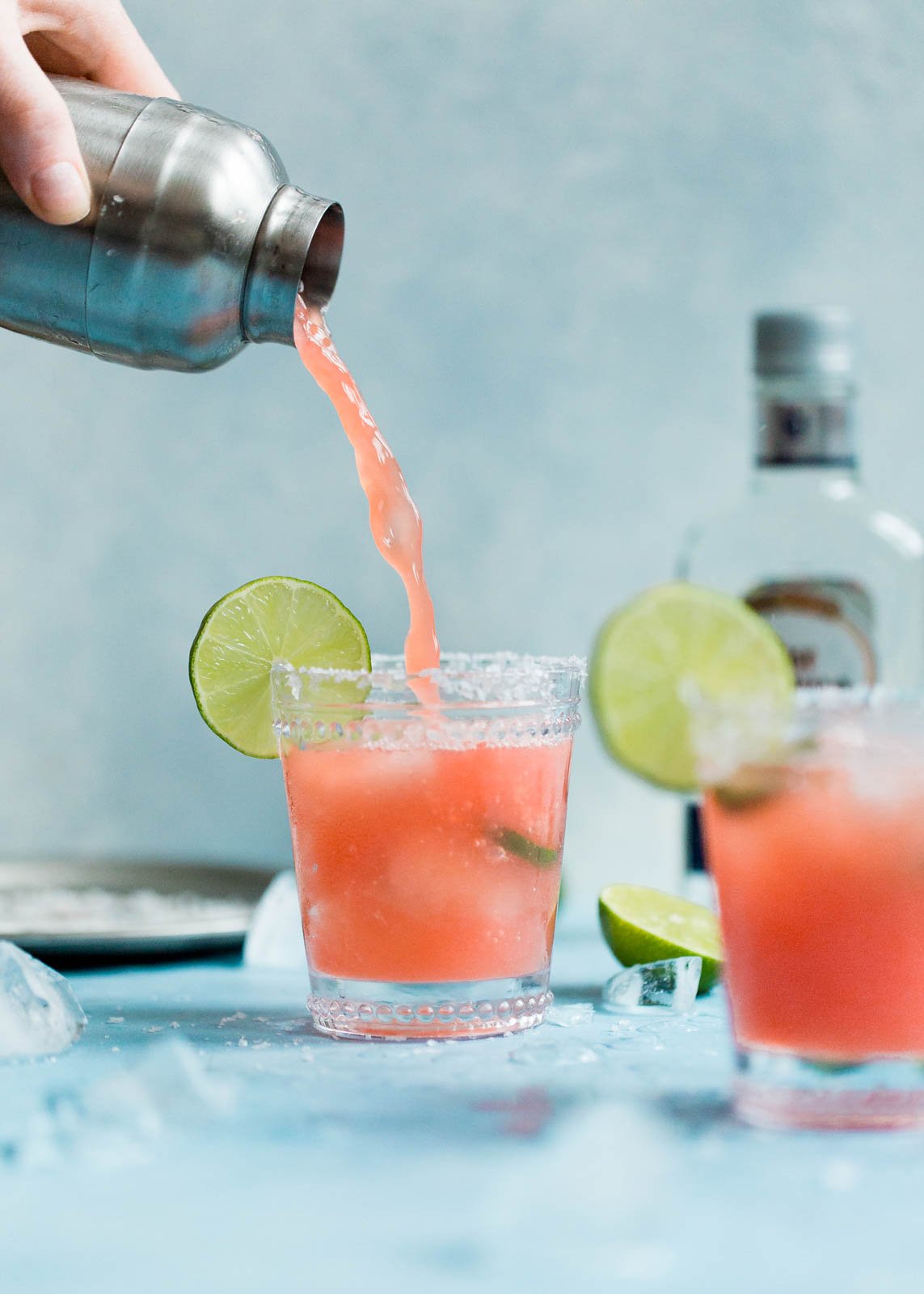 pouring a skinny watermelon margarita into a glass