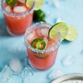 Skinny Jalapeño Watermelon Margaritas in two glasses with lime and jalapeño slices