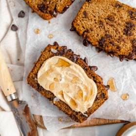 slice of almond flour pumpkin bread with butter and honey