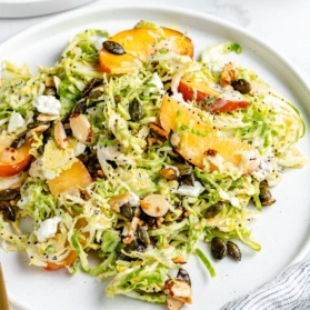 peach brussels sprouts salad on a plate