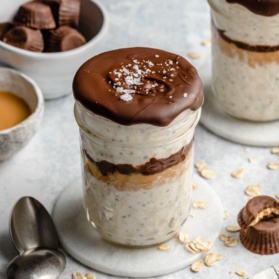 peanut butter overnight oats in a jar topped with a chocolate shell
