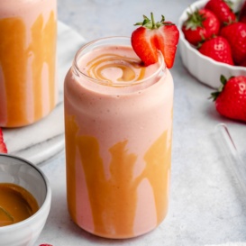 peanut butter strawberry banana smoothie in a glass