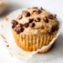peanut butter banana muffins with chocolate chips on a grey surface