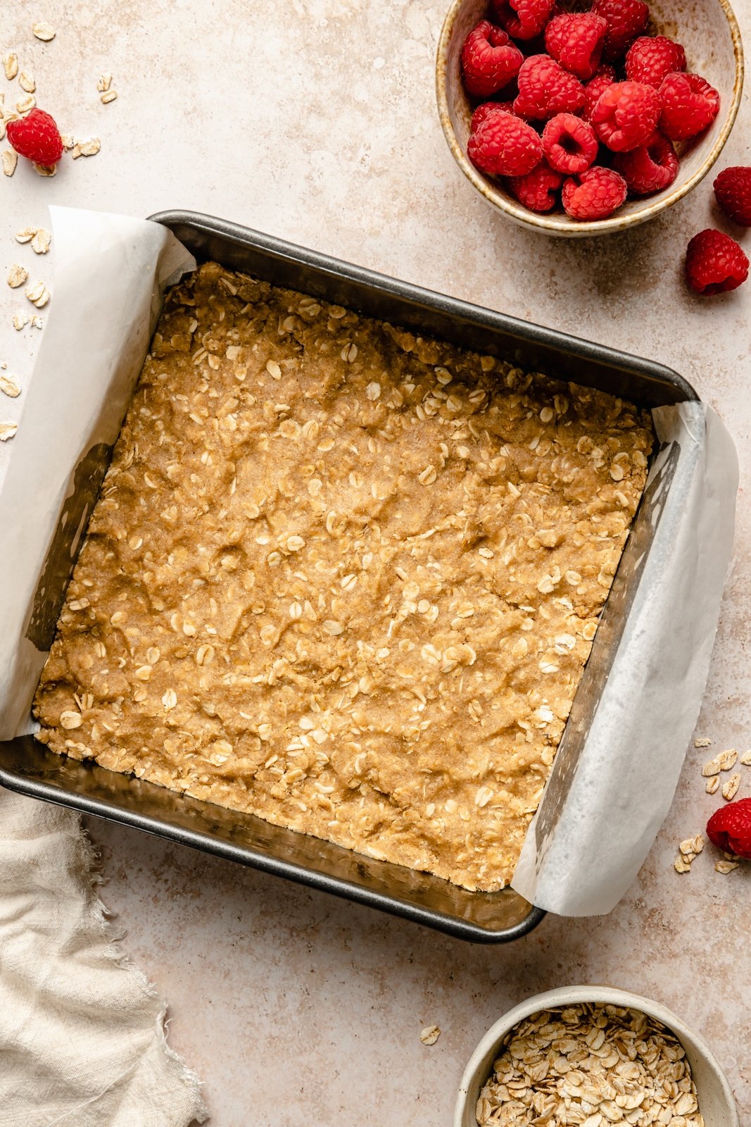 unbaked crust for raspberry bars in a baking pan