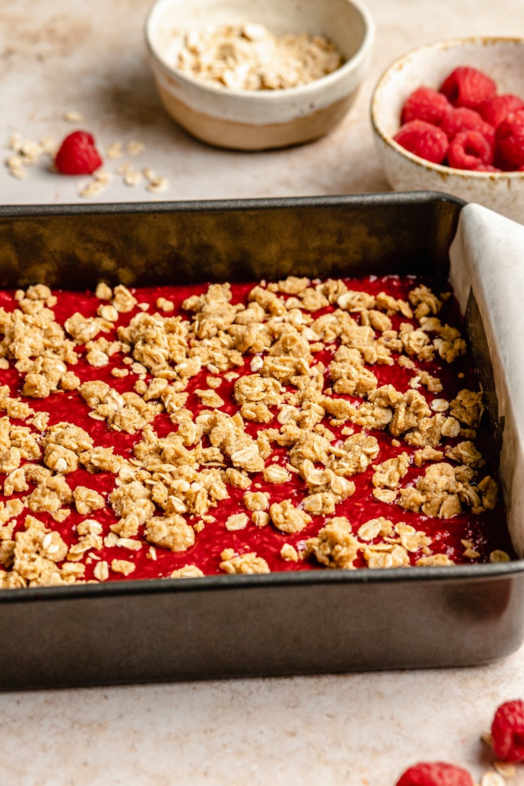 raspberry pie bars uncut in a baking pan