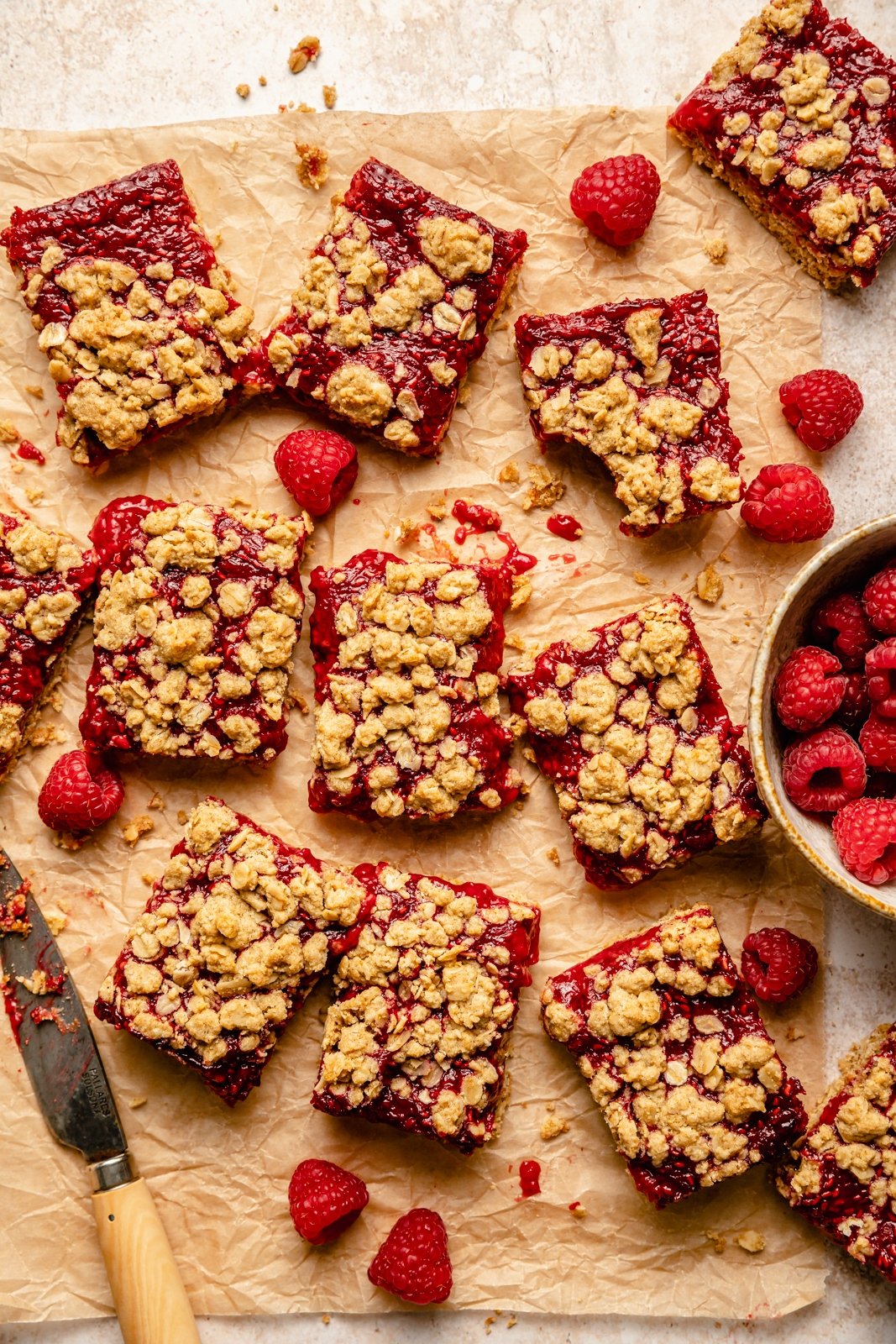 gluten free raspberry bars on parchment paper