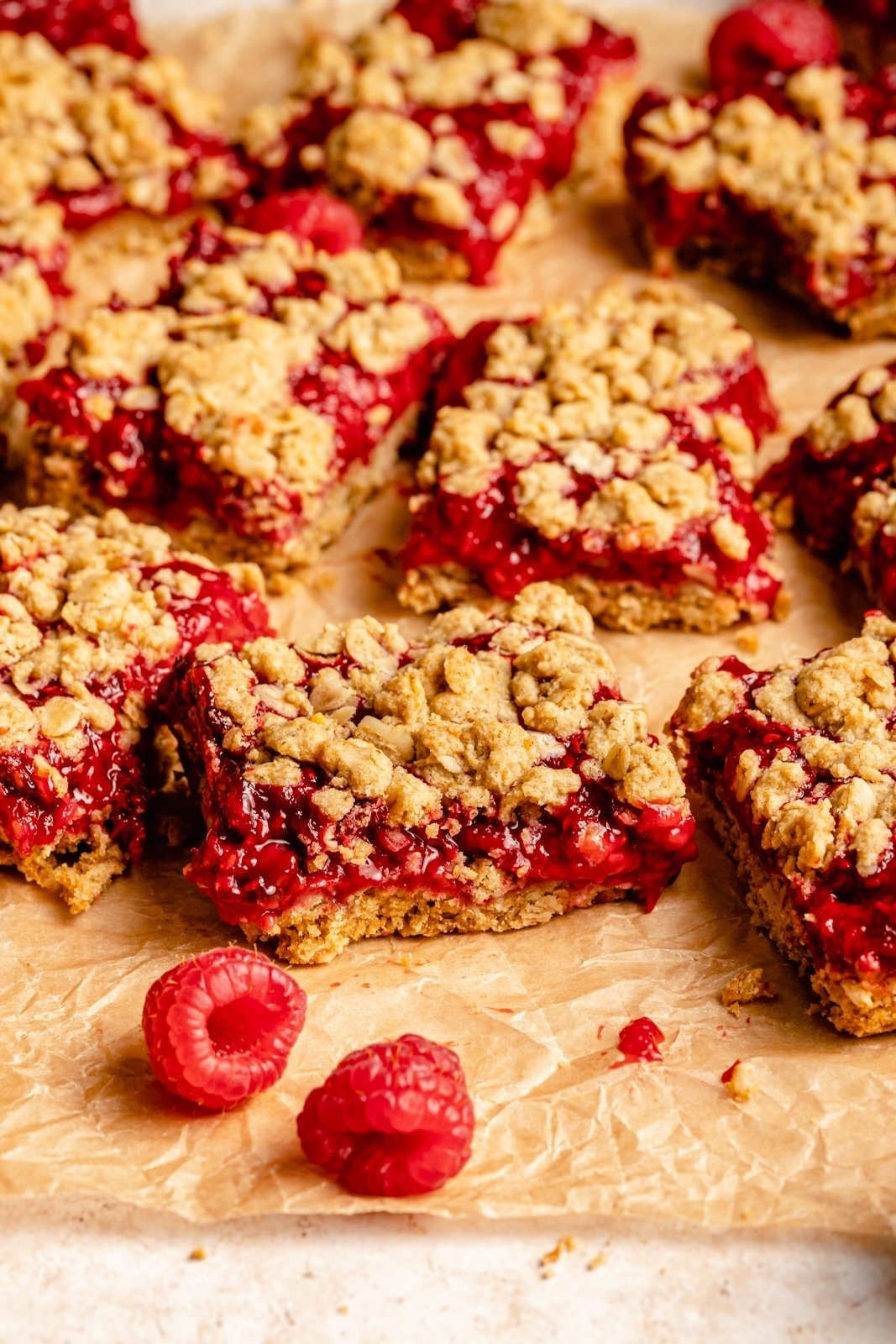 healthy raspberry bars on parchment paper