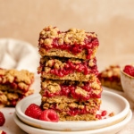 healthy raspberry bars in a stack on a plate