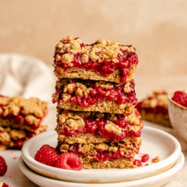 healthy raspberry bars in a stack on a plate