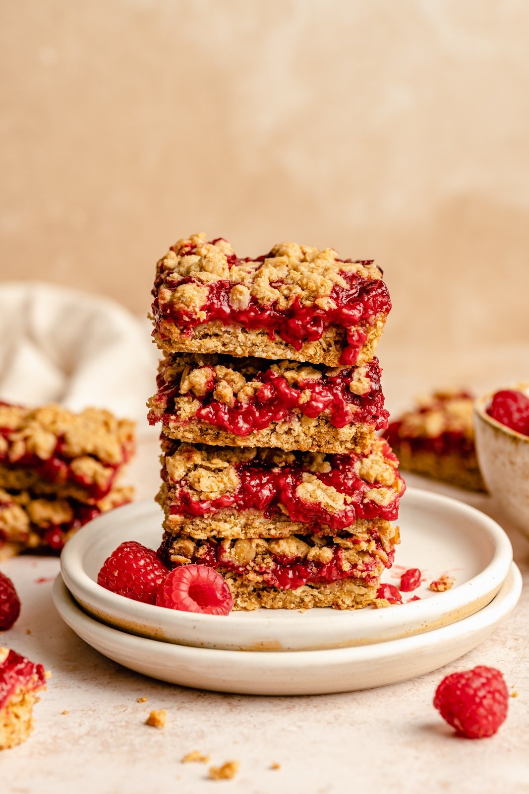 raspberry bars in a stack on a plate