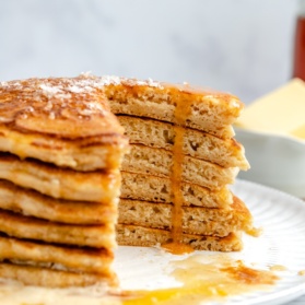 brown butter pancakes in a stack with a slice cut out