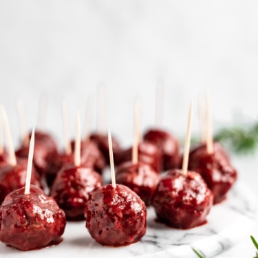 slow cooker bbq cranberry turkey meatballs on a platter with toothpicks