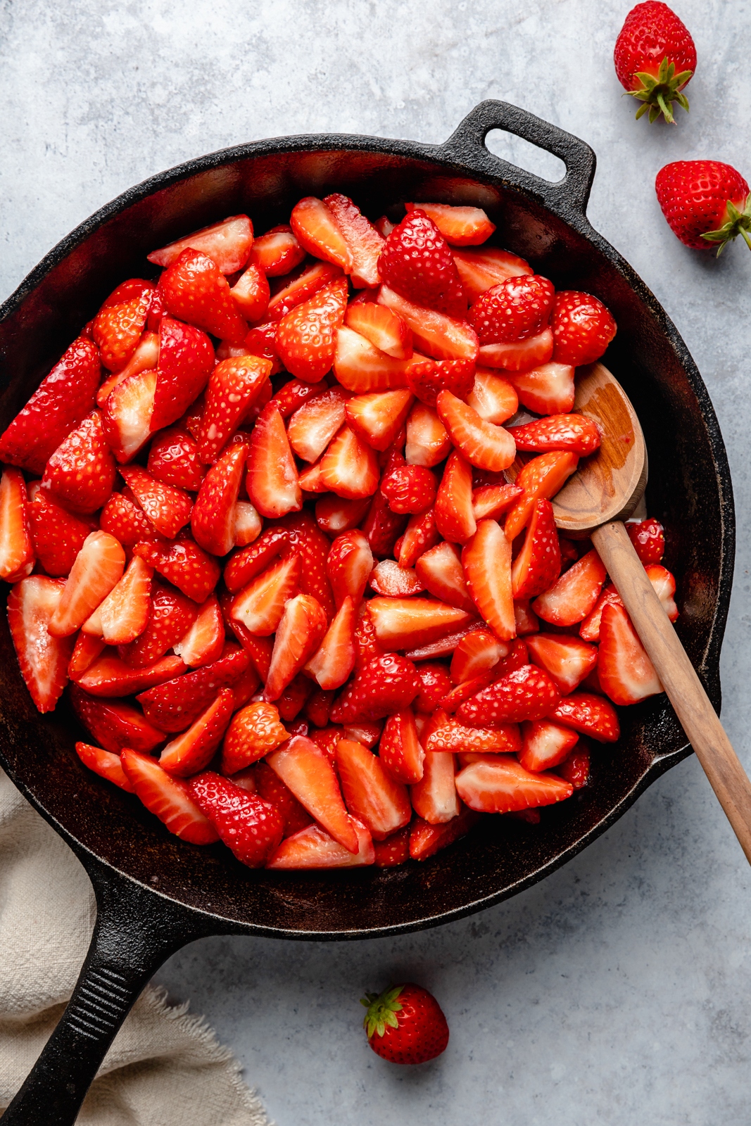 strawberries in a skillet to make a healthy strawberry crisp recipe
