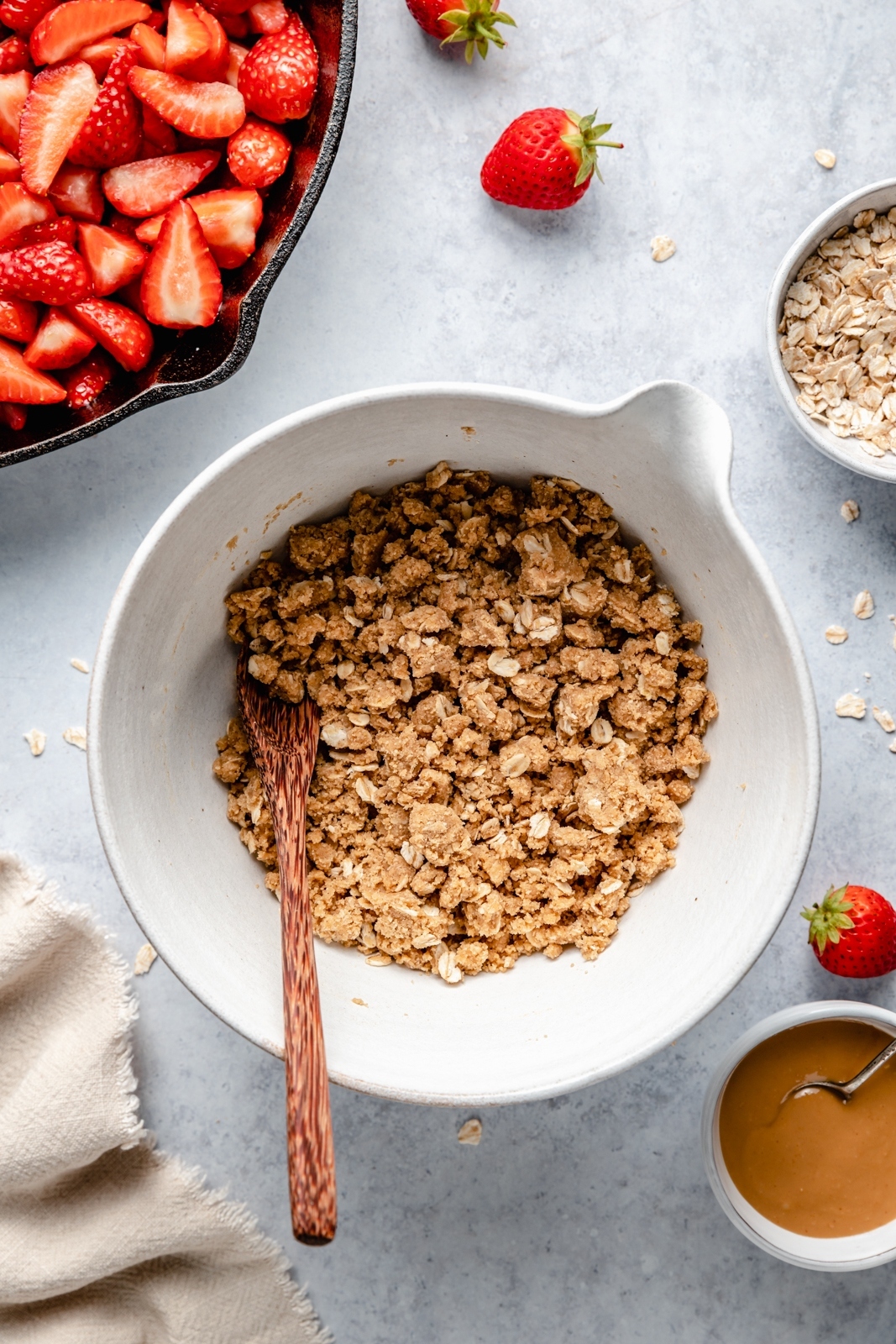 mixing a peanut butter oatmeal cookie crumble topping for strawberry crisp